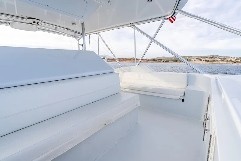 Determined Yacht Photos Pics 2003 Hatteras 60 Convertible yacht, spacious seating area, ocean view, clear skies.