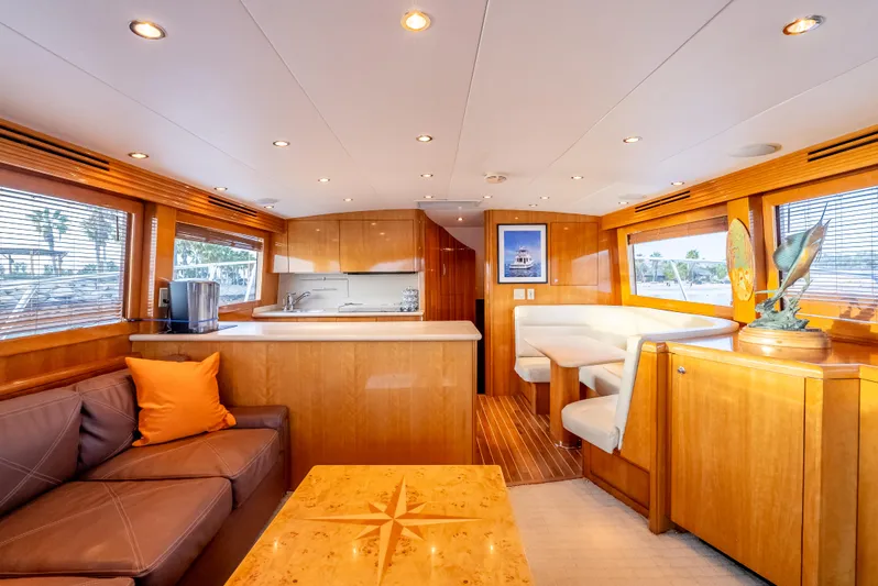 Determined Yacht Photos Pics Luxurious interior of 2003 Hatteras 60 Convertible yacht with wood finishes and cozy seating.