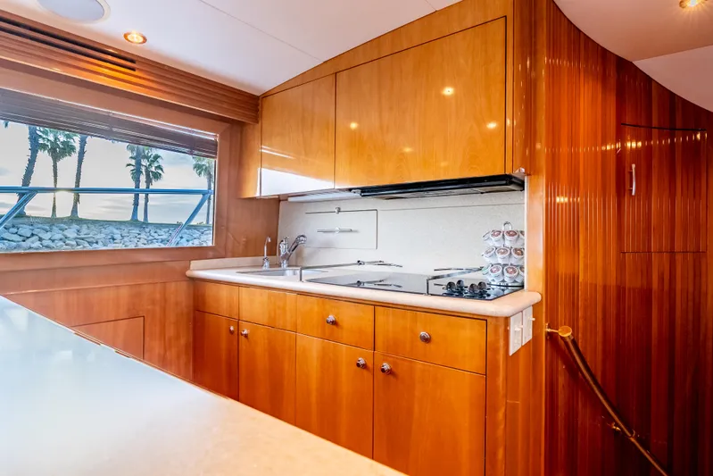 Determined Yacht Photos Pics Interior of 2003 Hatteras 60 Convertible yacht kitchen with wooden cabinetry and modern appliances.