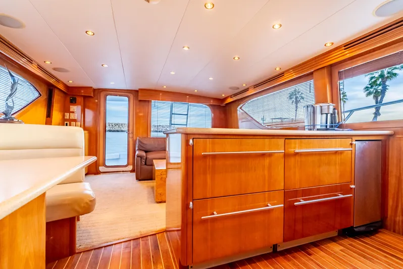 Determined Yacht Photos Pics Luxurious interior of 2003 Hatteras 60 Convertible yacht with wooden cabinetry and seating.