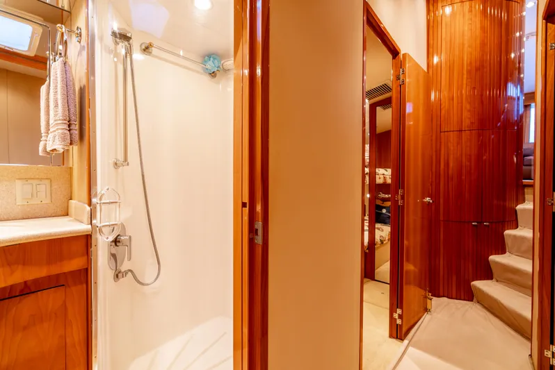 Determined Yacht Photos Pics Interior of 2003 Hatteras 60 Convertible yacht, featuring a shower and wooden cabinetry.
