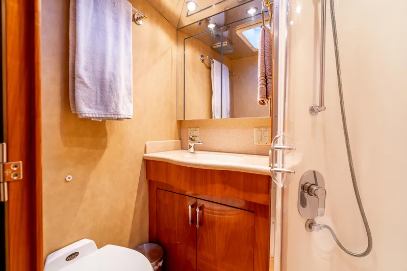 Determined Yacht Photos Pics Bathroom interior of 2003 Hatteras 60 Convertible yacht with shower and wooden cabinetry.