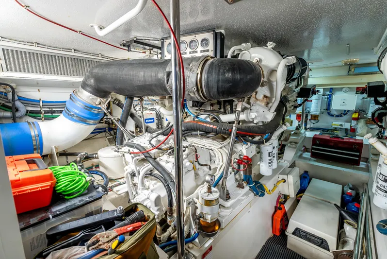 Determined Yacht Photos Pics Engine room of a 2003 Hatteras 60 Convertible yacht, showcasing machinery and equipment.