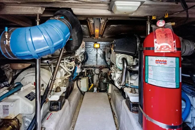 Megusta Yacht Photos Pics Engine room of 2007 Sea Ray 44 Sedan Bridge with fire extinguisher and mechanical components.