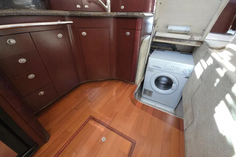 Megusta Yacht Photos Pics 2007 Sea Ray 44 Sedan Bridge interior with wood flooring and built-in washing machine.