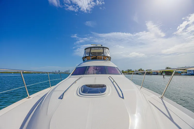 Megusta Yacht Photos Pics 2007 Sea Ray 44 Sedan Bridge yacht on calm water under a clear blue sky.