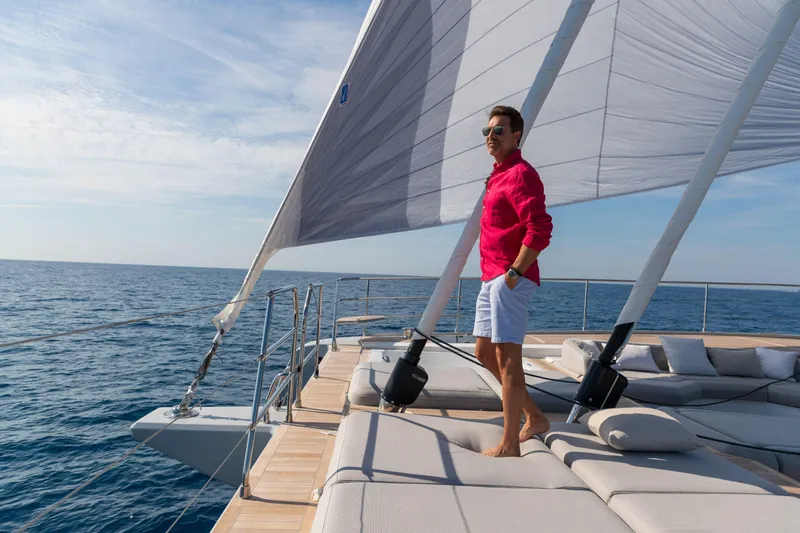 Serenissima III Yacht Photos Pics Man enjoying the view on a 2025 Fountaine Pajot Thira 80 yacht deck.