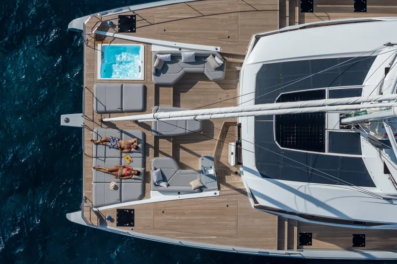 Serenissima III Yacht Photos Pics Aerial view of 2025 Fountaine Pajot Thira 80 yacht with sunbathers and jacuzzi.
