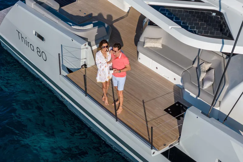 Serenissima III Yacht Photos Pics Couple enjoying a sunny day on the 2025 Fountaine Pajot Thira 80 yacht deck.