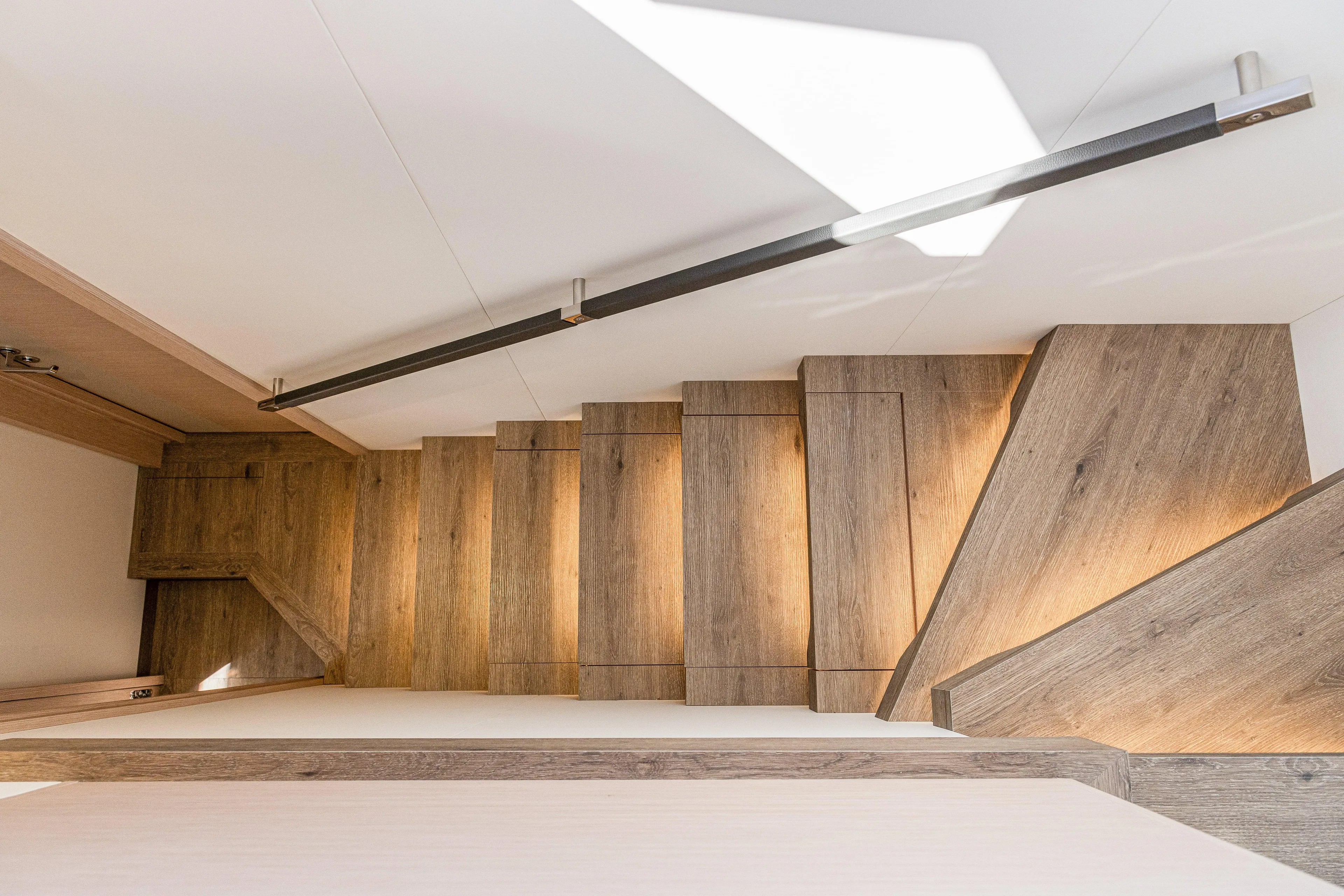 Serenissima III Yacht Photos Pics Wooden staircase with modern lighting on the 2025 Fountaine Pajot Thira 80 yacht.