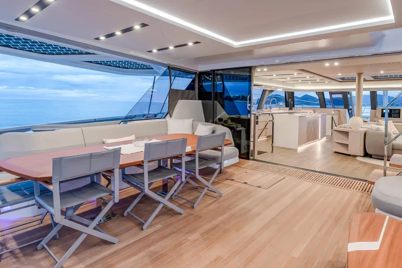 Serenissima III Yacht Photos Pics Luxurious 2025 Fountaine Pajot Thira 80 yacht interior with spacious dining and lounge area.