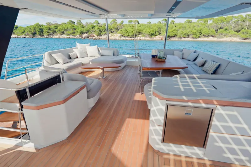Serenissima III Yacht Photos Pics Luxurious 2025 Fountaine Pajot Thira 80 yacht deck with elegant seating and ocean view.