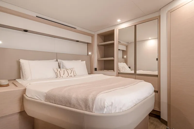 Serenissima III Yacht Photos Pics Luxurious bedroom interior of 2025 Fountaine Pajot Thira 80 yacht, featuring elegant design.
