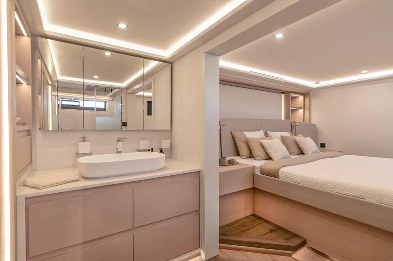 Serenissima III Yacht Photos Pics Luxurious interior of 2025 Fountaine Pajot Thira 80 yacht, featuring elegant bedroom and bathroom.