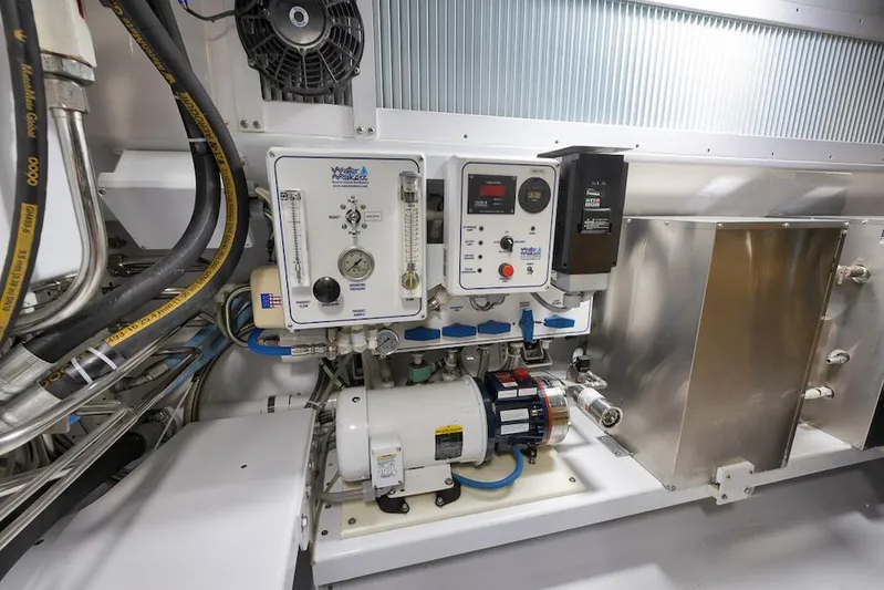 Bree Yacht Photos Pics Engine room of 2016 Merritt 86' Enclosed Flybridge, showcasing mechanical equipment and control panels.