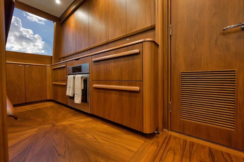 Bree Yacht Photos Pics Luxurious wood interior of 2016 Merritt 86' Enclosed Flybridge yacht kitchen.