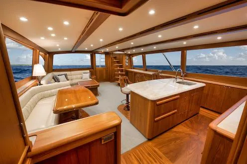 Bree Yacht Photos Pics Luxurious interior of 2016 Merritt 86' Enclosed Flybridge yacht with wood finishes and ocean view.