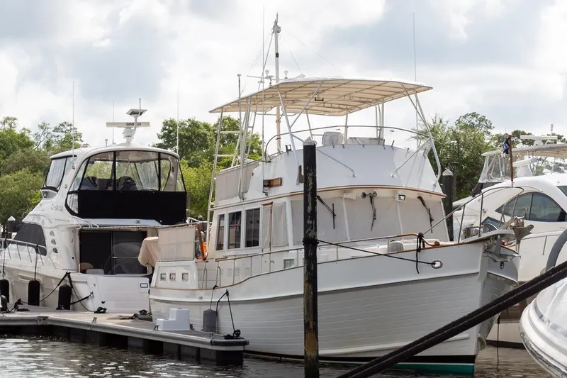 Sandy Isles Yacht Photos Pics 1993 Grand Banks 46 Motoryacht docked at marina, surrounded by other boats.