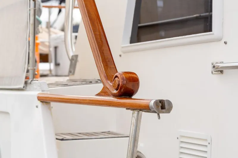 Sandy Isles Yacht Photos Pics Polished wooden handrail on 1993 Grand Banks 46 Motoryacht, showcasing elegant craftsmanship.