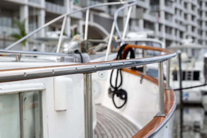Sandy Isles Yacht Photos Pics Close-up of 1993 Grand Banks 46 Motoryacht railing, docked in a marina.
