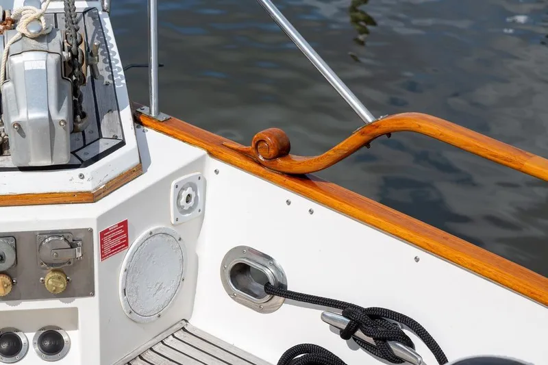 Sandy Isles Yacht Photos Pics 1993 Grand Banks 46 Motoryacht deck with wooden rail and nautical equipment.