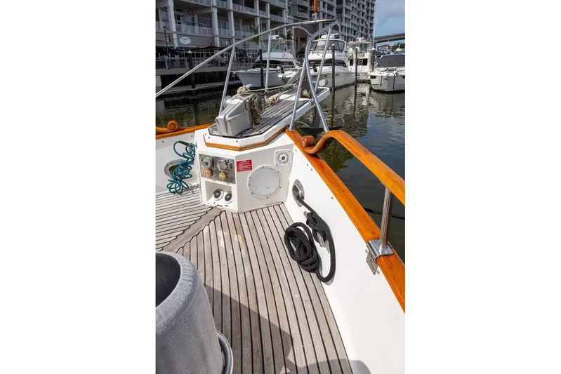 Sandy Isles Yacht Photos Pics 1993 Grand Banks 46 Motoryacht deck with wood finish and marina view.