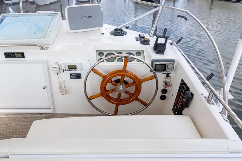 Sandy Isles Yacht Photos Pics 1993 Grand Banks 46 Motoryacht helm with wooden wheel and navigation equipment.