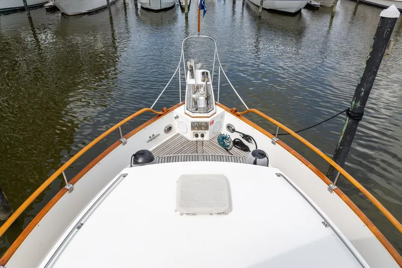 Sandy Isles Yacht Photos Pics Bow view of 1993 Grand Banks 46 Motoryacht docked in a marina.