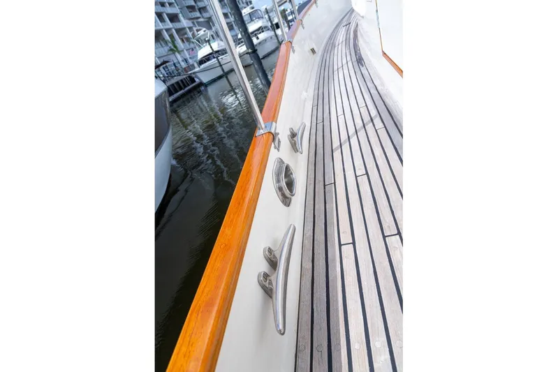 Sandy Isles Yacht Photos Pics Deck view of 1993 Grand Banks 46 Motoryacht with wooden rail and cleats.