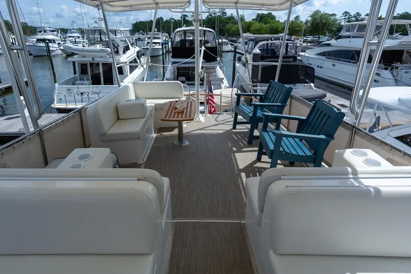 Sandy Isles Yacht Photos Pics 1993 Grand Banks 46 Motoryacht deck with seating, docked at marina.