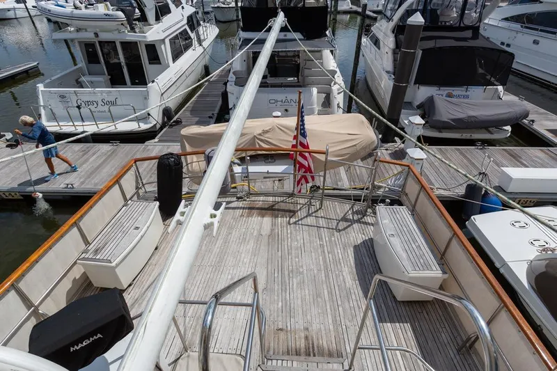 Sandy Isles Yacht Photos Pics 1993 Grand Banks 46 Motoryacht docked, featuring spacious deck and American flag.