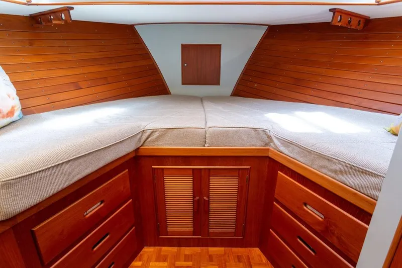 Sandy Isles Yacht Photos Pics Cozy cabin interior of 1993 Grand Banks 46 Motoryacht with wooden finish and storage drawers.