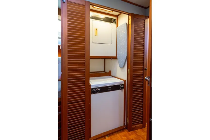 Sandy Isles Yacht Photos Pics Laundry area in 1993 Grand Banks 46 Motoryacht with wooden louvered doors.