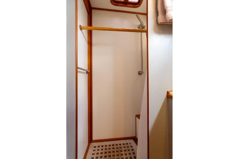 Sandy Isles Yacht Photos Pics Shower area in 1993 Grand Banks 46 Motoryacht with wooden accents and towel rack.