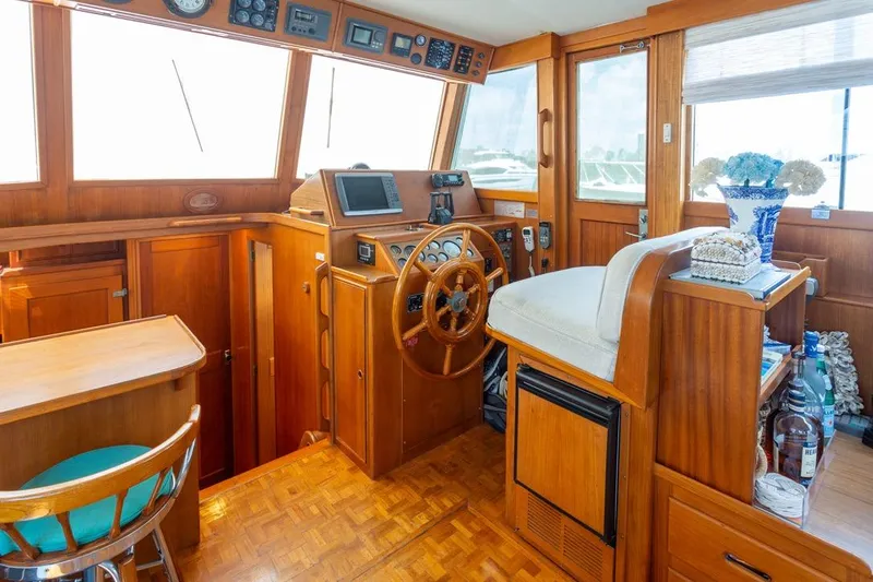 Sandy Isles Yacht Photos Pics 1993 Grand Banks 46 Motoryacht helm with wooden interior and nautical decor.