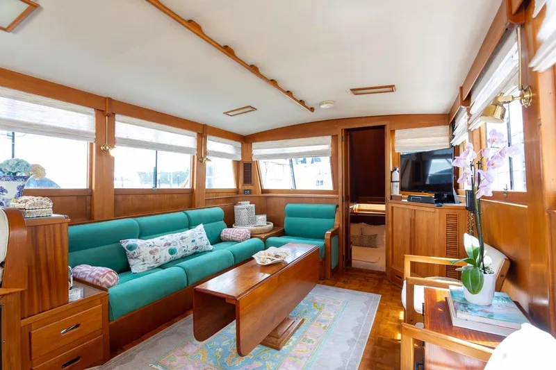 Sandy Isles Yacht Photos Pics Luxurious interior of 1993 Grand Banks 46 Motoryacht with teal seating and wooden accents.