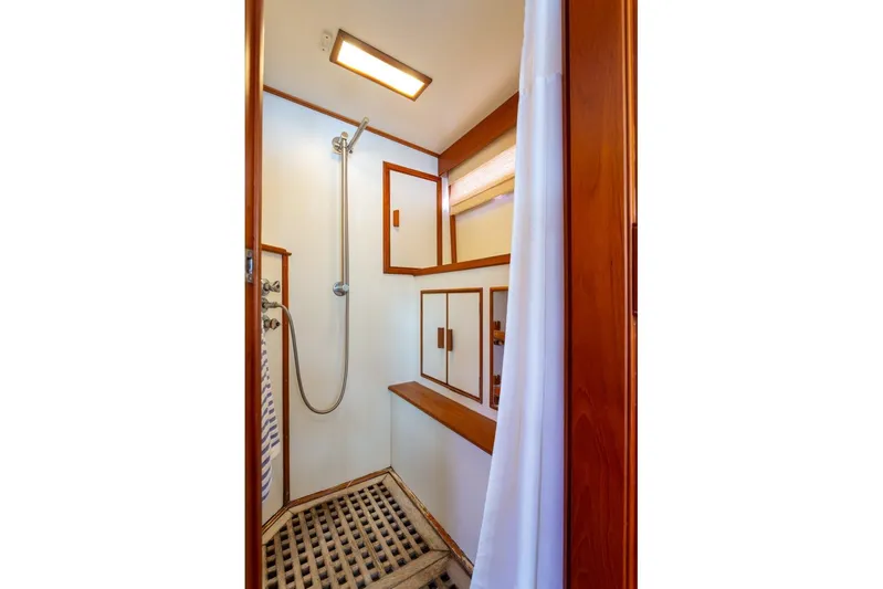 Sandy Isles Yacht Photos Pics Shower area in 1993 Grand Banks 46 Motoryacht with wooden accents and modern fixtures.