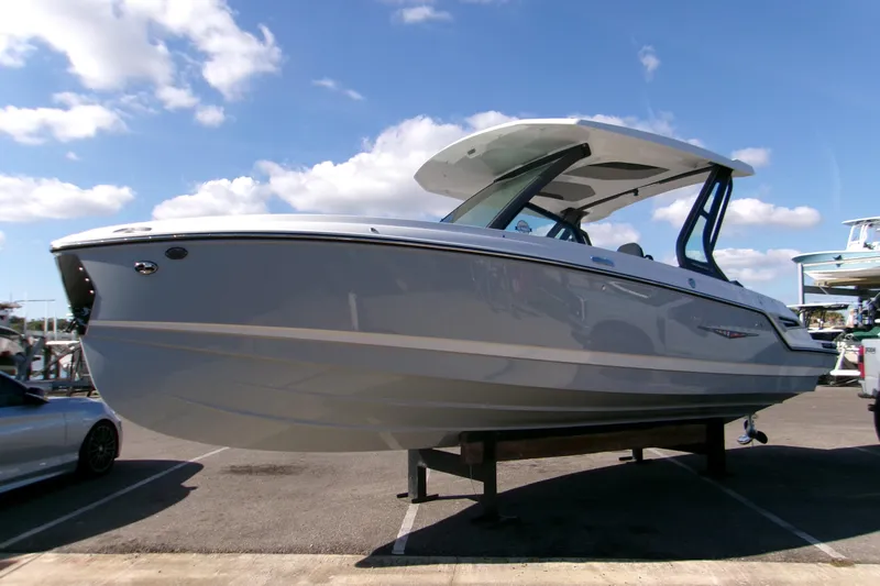  Yacht Photos Pics 2026 Monterey Elite 25 OB boat displayed outdoors under a clear blue sky.