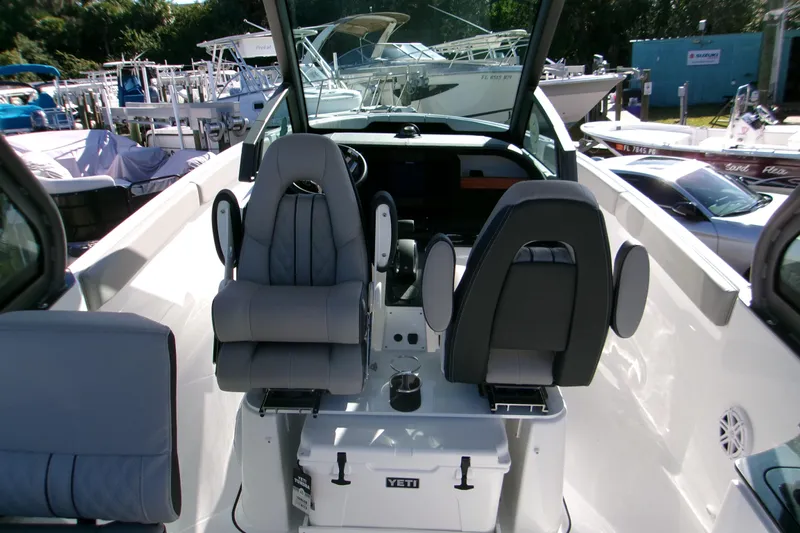  Yacht Photos Pics 2026 Monterey Elite 25 OB boat interior with modern seating and Yeti cooler.