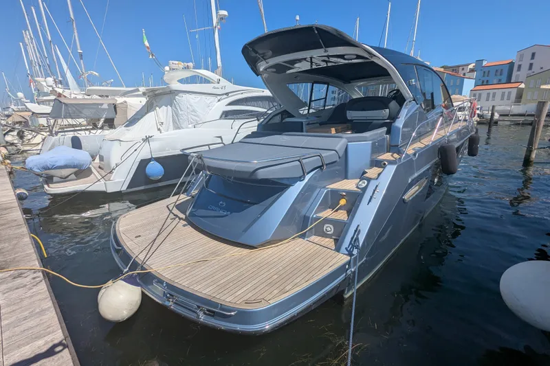  Yacht Photos Pics 2016 Cranchi M 44 HT yacht docked in a marina under clear blue skies.
