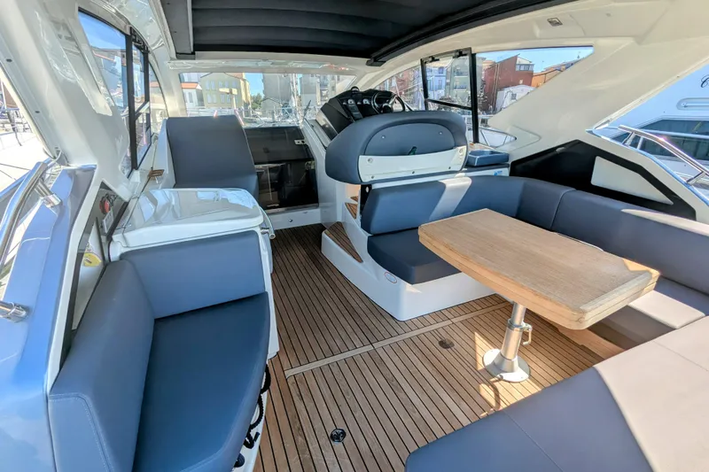  Yacht Photos Pics Luxurious interior of 2016 Cranchi M 44 HT yacht with sleek seating and wooden table.