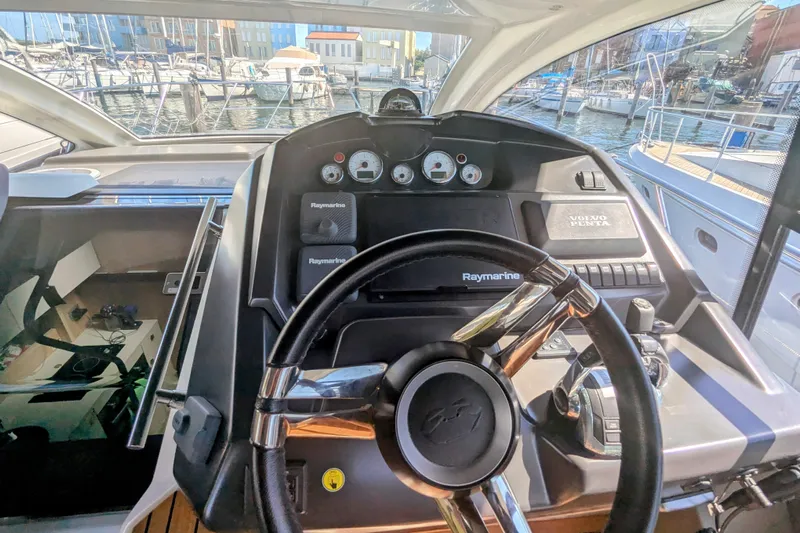  Yacht Photos Pics Helm of 2016 Cranchi M 44 HT yacht with Raymarine navigation system.