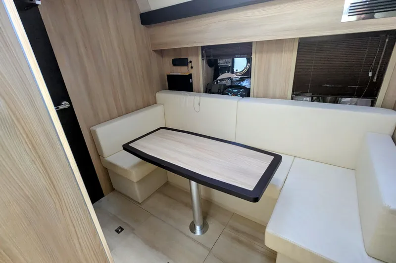  Yacht Photos Pics Interior of 2016 Cranchi M 44 HT yacht with modern seating and wooden table.
