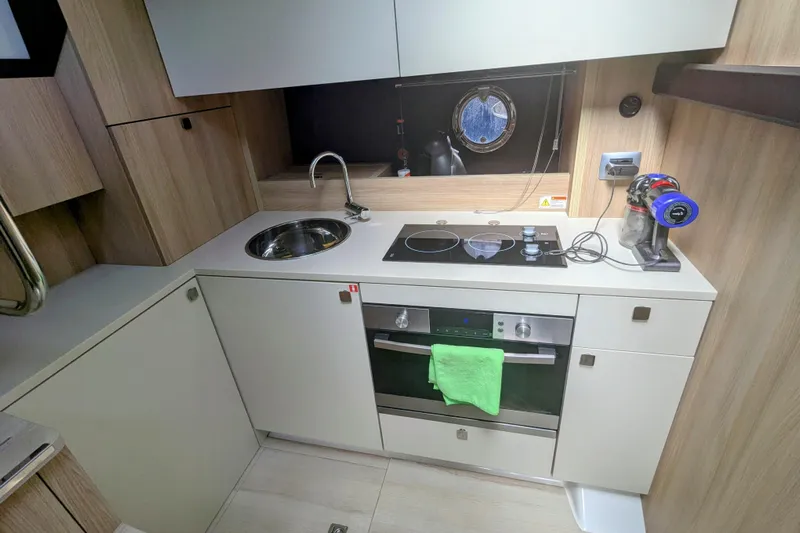  Yacht Photos Pics Modern kitchen in 2016 Cranchi M 44 HT yacht with stove, sink, and oven.