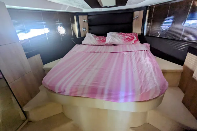  Yacht Photos Pics Luxurious bedroom interior of 2016 Cranchi M 44 HT yacht with pink bedding.