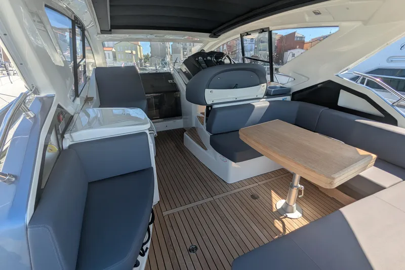  Yacht Photos Pics 2016 Cranchi M 44 HT yacht interior with sleek seating and wooden table.