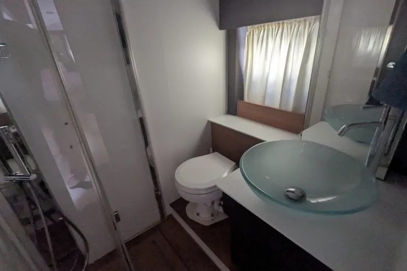  Yacht Photos Pics Bathroom interior of 2016 Cranchi M 44 HT yacht with glass sink and shower.