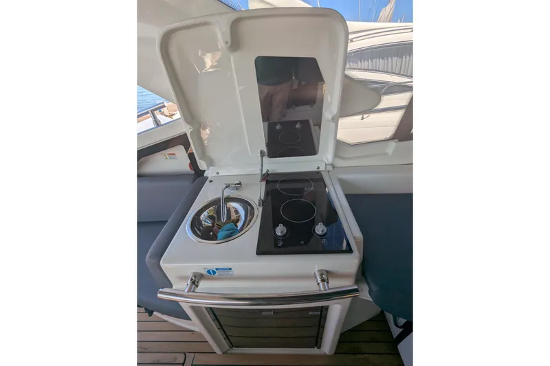  Yacht Photos Pics Cranchi M 44 HT 2016 yacht kitchenette with sink and stove, open lid view.