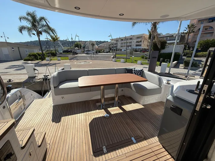 Yacht Photos Pics 2025 Azimut Fly 53 yacht deck with seating and table, docked at marina.
