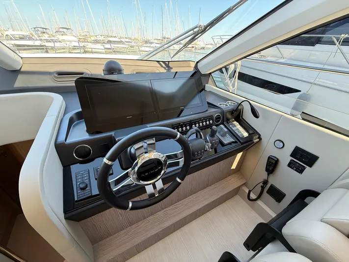  Yacht Photos Pics Helm of 2025 Azimut Fly 53 yacht with modern controls and steering wheel.